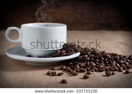 coffee beans on fabric tablecloth with aged wood background