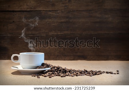 coffee beans on fabric tablecloth with aged wood background