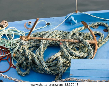 Rusty anchor on deck of an old,  small sailboat, Kinvara, Ireland