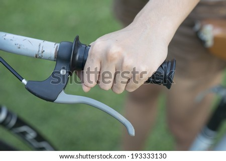 Hand holding bicycle handlebar