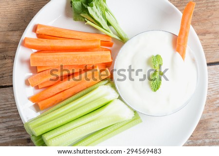 Vegetable sticks. Fresh celery and carrot with yogurt sauce