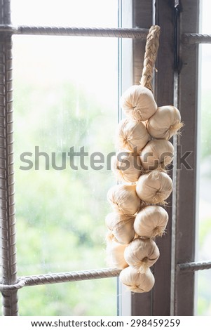 Fake garlic hang on steel window.