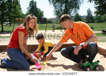 happy family is playing in park