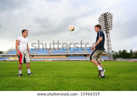 young guys playing football on stadium