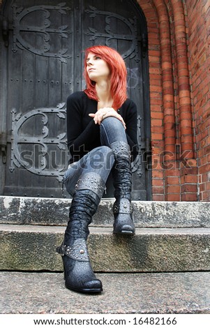 girl with red hair is sitting on the stairs