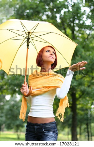 beautiful young girl under yellow umbrella