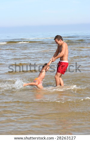 father and son swimming on the sea