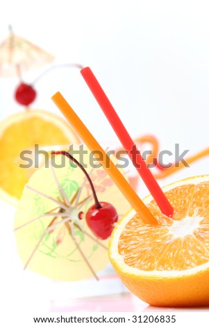 oranges with tubes and umbrellas isolated on white