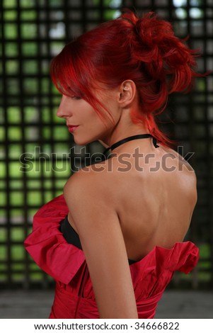 portrait of beautiful redhead woman in red dress