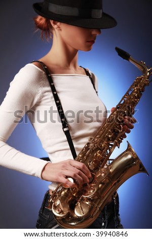 sexy young woman with saxophone (sax in focus)