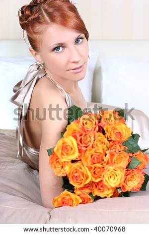 beautiful young woman with bunch of roses