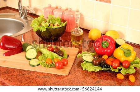 fresh vegetables and olive oil on a kitchen table