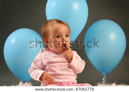 funny little girl with blue balloon