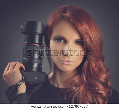 pretty young woman with camera