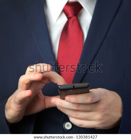 business man in blue suit with mobile phone