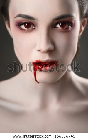 Portrait Of A Female Vampire Over Black Background
