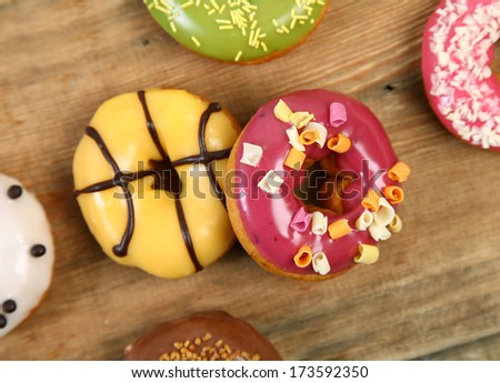 sweet bright donuts on wooden background