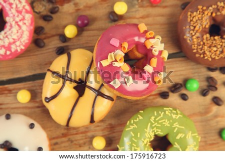 sweet bright donuts on wooden background