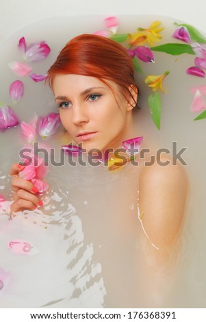 woman in bath with flowers