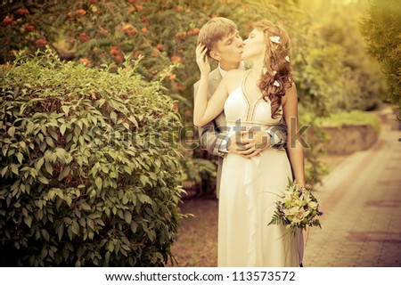 Groom and Bride in a park. wedding dress. Bridal wedding bouquet of flowers