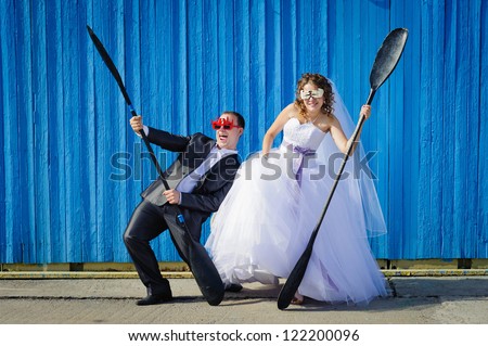 funny Groom and Bride with oars