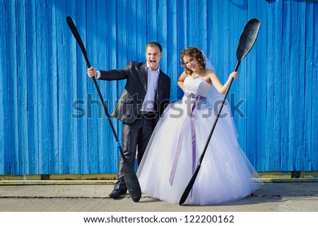 funny Groom and Bride with oars