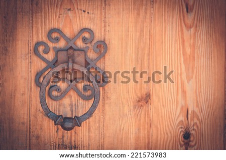 The detail of an old large oak door with iron pull