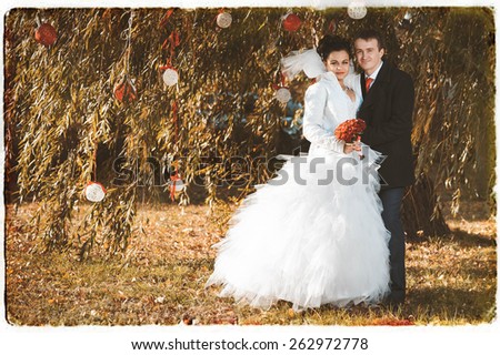 young funny bride and groom having fun in the park
