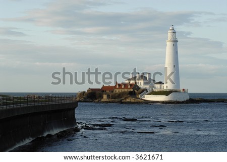 St Mary\'s Lighthouse at Sunset with the tide covering the causeway to the island