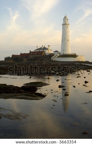 Panoramic view of St Mary\'s Lighthouse at Sunset with the tide out exposing causeway to island
