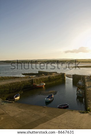 Beadnell Harbour at sunset. Englands only easterley facing harbour on the east coast of England