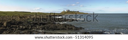 Ancient ruins of Dunstanburgh Castle overlooking the North Sea