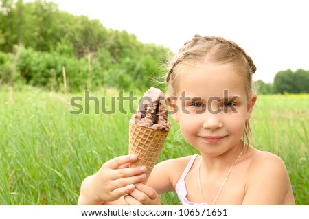 girl holding in their hands and eating ice cream, the girl loves to eat ice cream