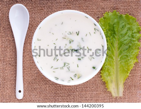 Close-up of russian cold vegetable soup on yoghurt (sour-milk) base - okroshka