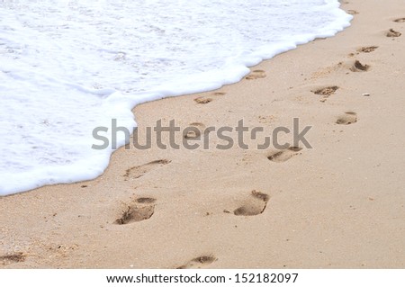 Human footprints on the sand beach