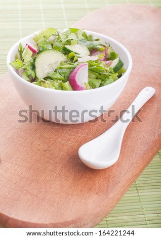 Chopped salad with goat cheese on a green background