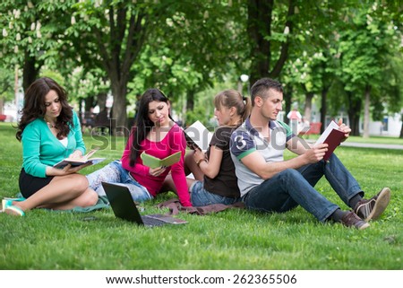 Group of Teenage Students at Park with Computer and Books