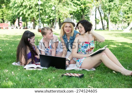students having lesson outdoor, Students read a book in the park