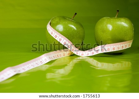 two apples with centimeter,greenbackground