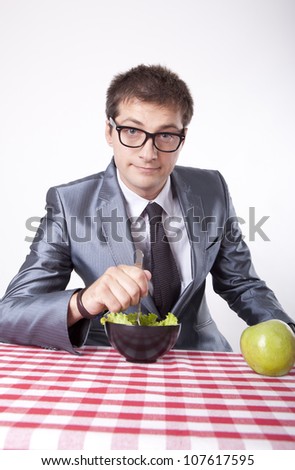 Young man eating salad.