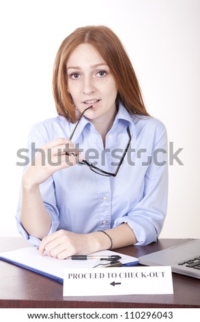 Portrait of a young attractive female secretary with a sign proceed to check out.