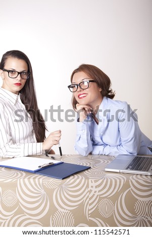 Portrait of a two young beautiful female secretaries.