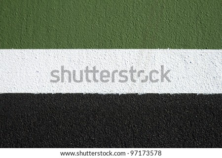 Green white and black horizontal stripes on a tennis court for back ground or texture.