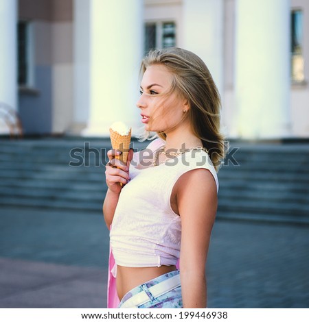 Beautiful fashion young girl posing with ice-cream