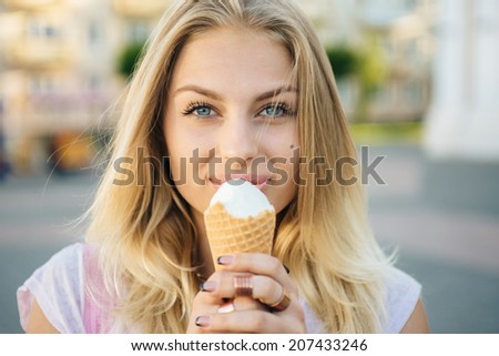 beautiful blonde with ice cream in the city.portrait