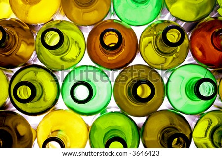 stack of assorted empty wine bottles backlited