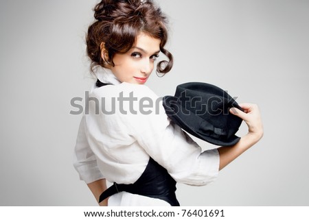 stock photo young gorgeous brunette posing with hat studio shot