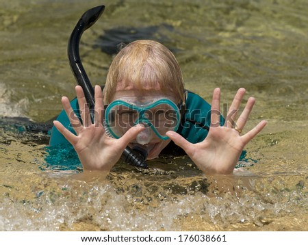 Older Woman at the beach with her snorkel equipment