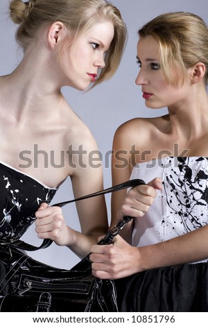 two woman fighting over a bag