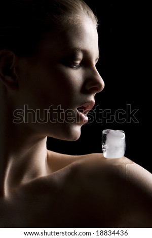 Beautiful woman with ice cube on shoulder